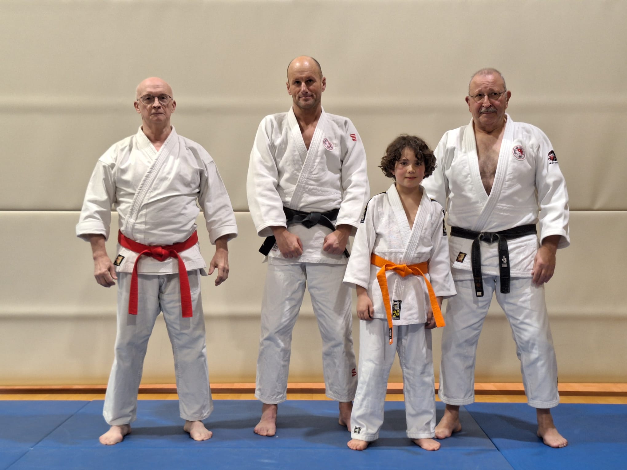A group of men in karate uniforms

Description automatically generated